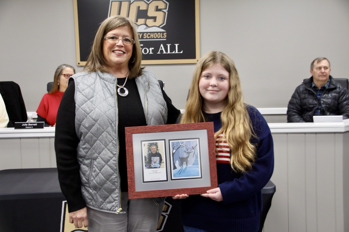 UCMS Principal Tammy Hughes with Seventh-Grader Sadie Cochran for the youngster’s recognition of having her artwork chosen for the system’s 2024 holiday card. Photo by Shawn Jarrard