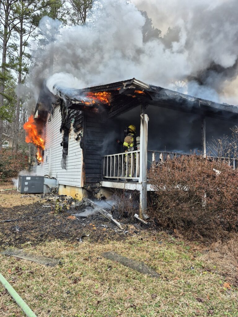 Union County Firefighters working hard to extinguish their first structure fire of the year on Forest Circle in northern Union County. Photo/Submitted