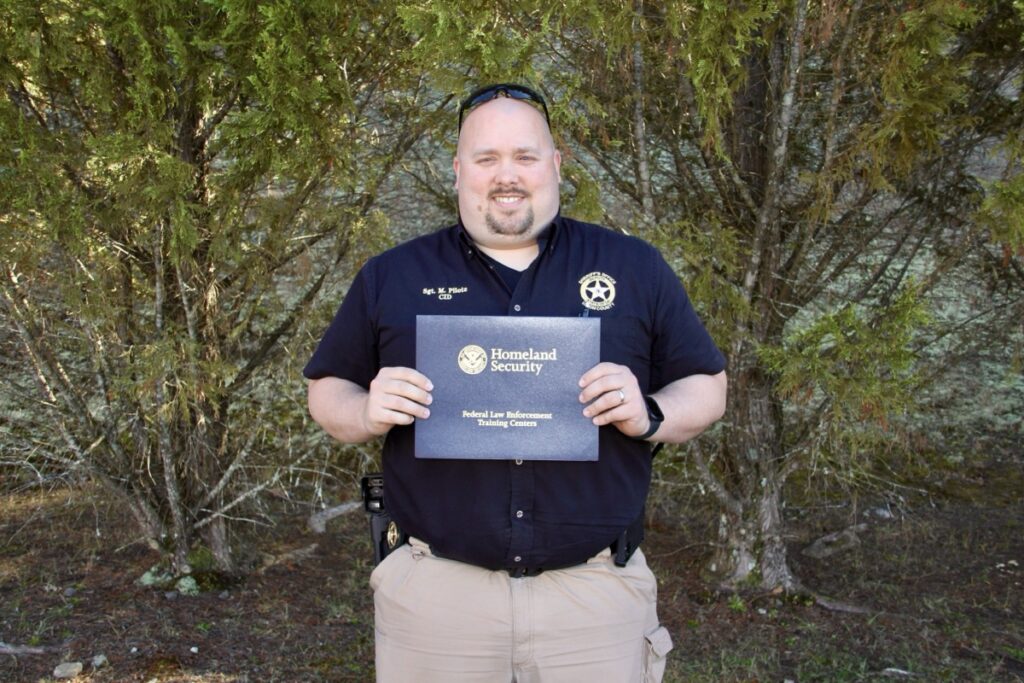 UCSO Sgt. Marc Pilote holding his Firearms Instructor certificate. Photo by Shawn Jarrard