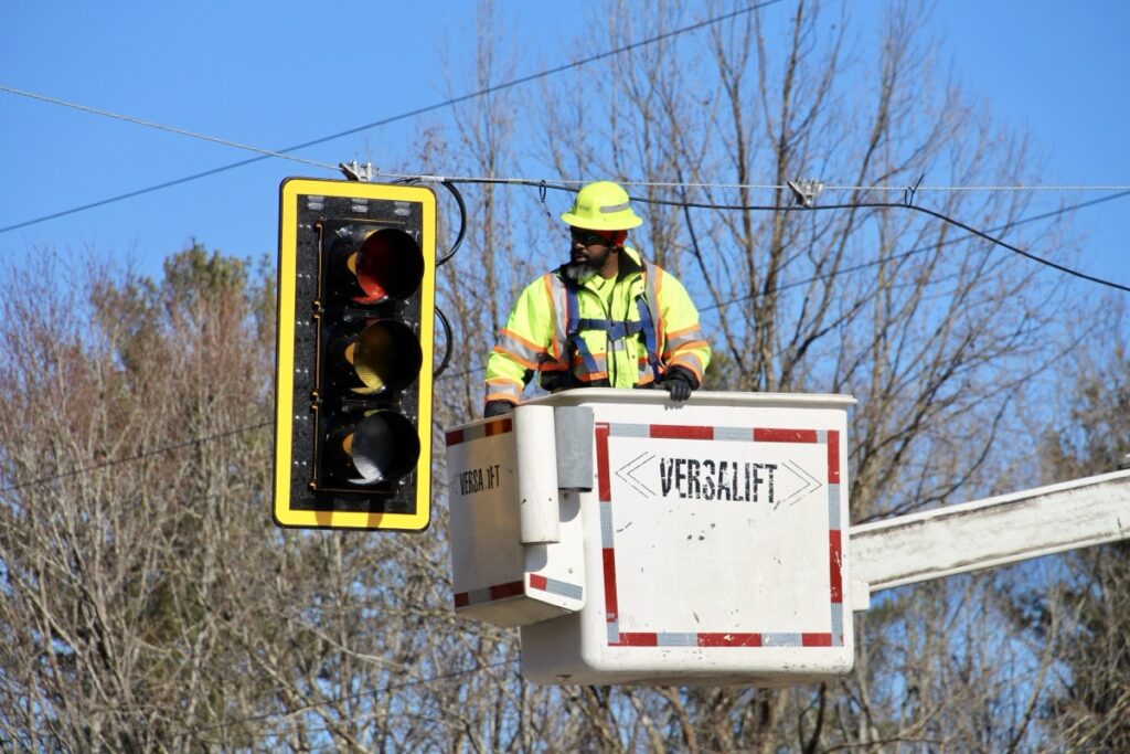 An employee with the Georgia Department of Transportation inspecting the installation of a new traffic light at Gainesville Highway and Shoe Factory Road on Jan. 28. Photo by Shawn Jarrard