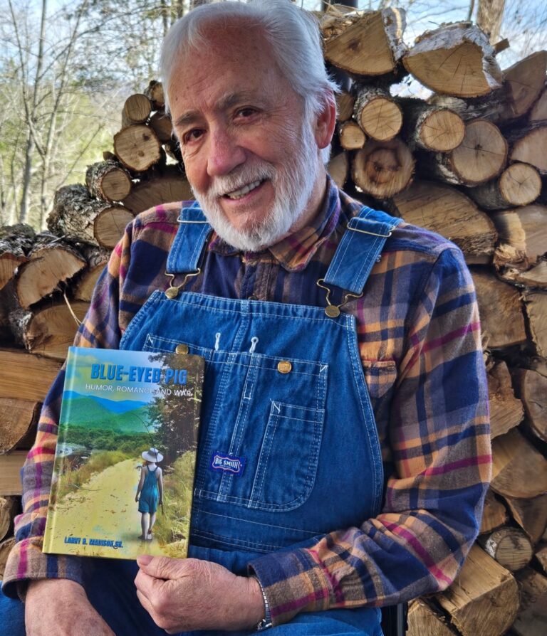 Larry N. Madison Sr. with his recently published first novel, “Blue-Eyed Pig: Humor, Romance and War.”