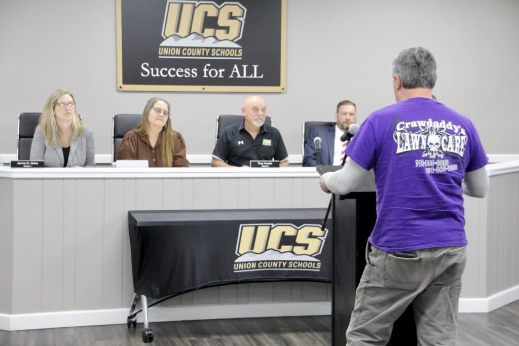 School Custodial Supervisor Mark Hughes delivering public comments in the March 18 Board of Education meeting. Photo by Shawn Jarrard
