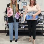 River City Universal Banker Alexis Moody and Human Resources Director Katie Mashburn promoting the Shoe Drive.