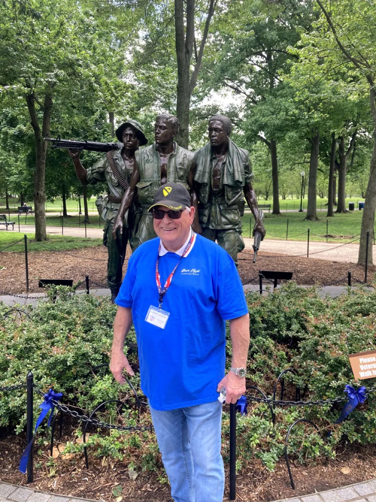 Reich posing with a statue honoring Vietnam Veterans during his Honor Flight experience.