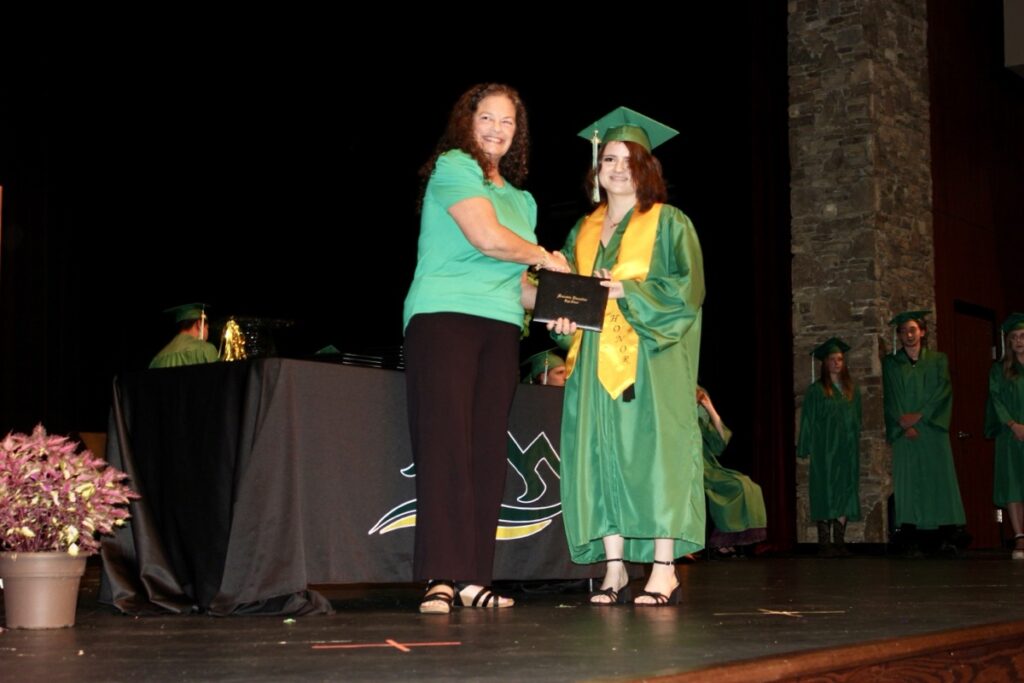 Mountain Education High School Class of 2025 Graduate Kaitlyn Dolby receiving her diploma from Union Campus Principal Jennifer Ludlum. Photo by Brittany Holbrooks