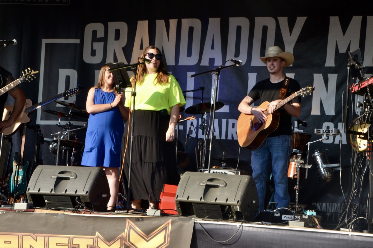 Grandaddy Mimm’s CEO Megan Kimsey welcoming folks to the Appalachian Roots Festival July 5 before Blairsville’s own Cody King opened the evening concert. Photo by Brittany Holbrooks