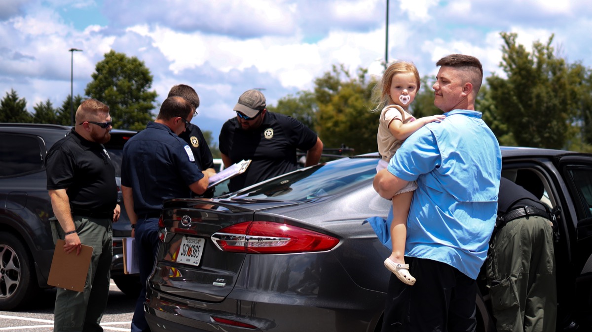 Parent Jacob White, right, drove one of the 12 cars that passed through the local car seat safety check at Walmart July 16. Photo by Daysha Pandolph