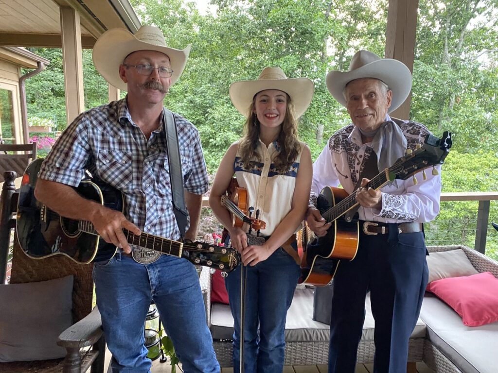 Moriah Owenby, center, with her father Wayne Owenby and mentor John Cochran of the local Western music group John Cochran and the Cowhands. Photo/Submitted