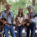 Moriah Owenby, center, with her father Wayne Owenby and mentor John Cochran of the local Western music group John Cochran and the Cowhands. Photo/Submitted