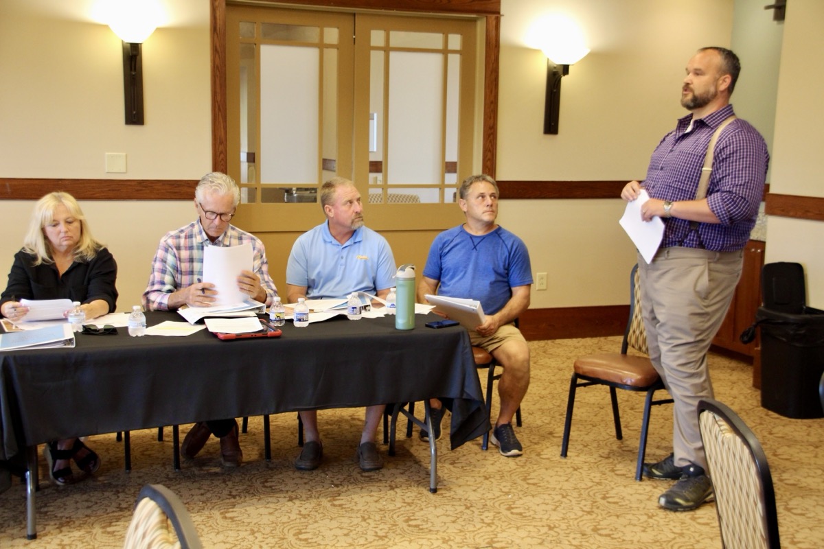 County Attorney William Mercer, right, went over the bylaws of the re-formed UCDA with directors on July 28. Photo by Shawn Jarrard