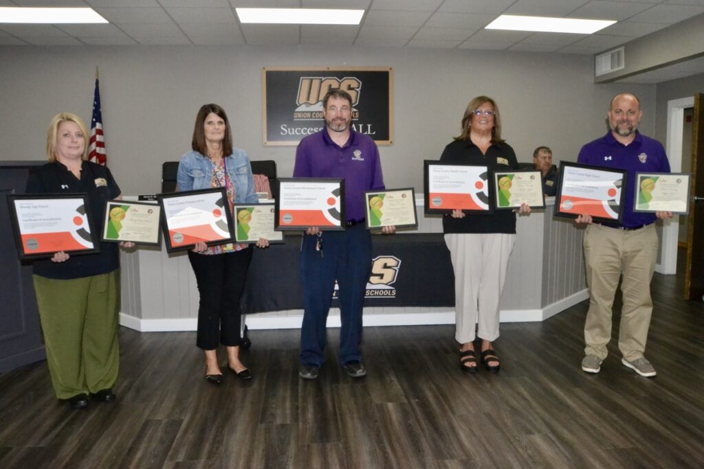 The principals of the five campuses across Union County Schools received certificates of accreditation and recognition in the July School Board meeting. Photo by Brittany Holbrooks