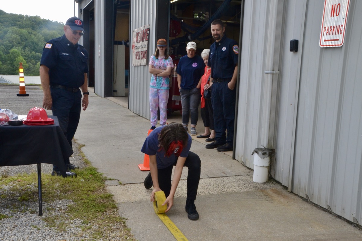 The annual Station 5 Open House in Suches always features interactive activities, like hose rolling seen in this photo. Photo by Brittany Holbrooks