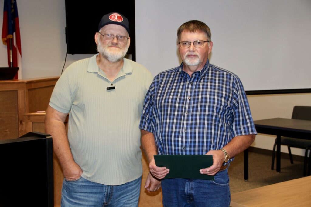 Commissioner Collins with retiring county employee Johnny Holbrooks on Aug. 21. Photo by Shawn Jarrard