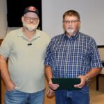 Commissioner Collins with retiring county employee Johnny Holbrooks on Aug. 21. Photo by Shawn Jarrard