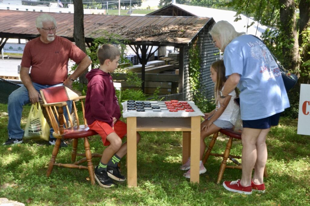 Among the many things to do at this year’s Mountain Heritage Festival, the age-old pastime of checkers provided families with a fun activity that was popular with the area’s forebears. Photo by Brittany Holbrooks