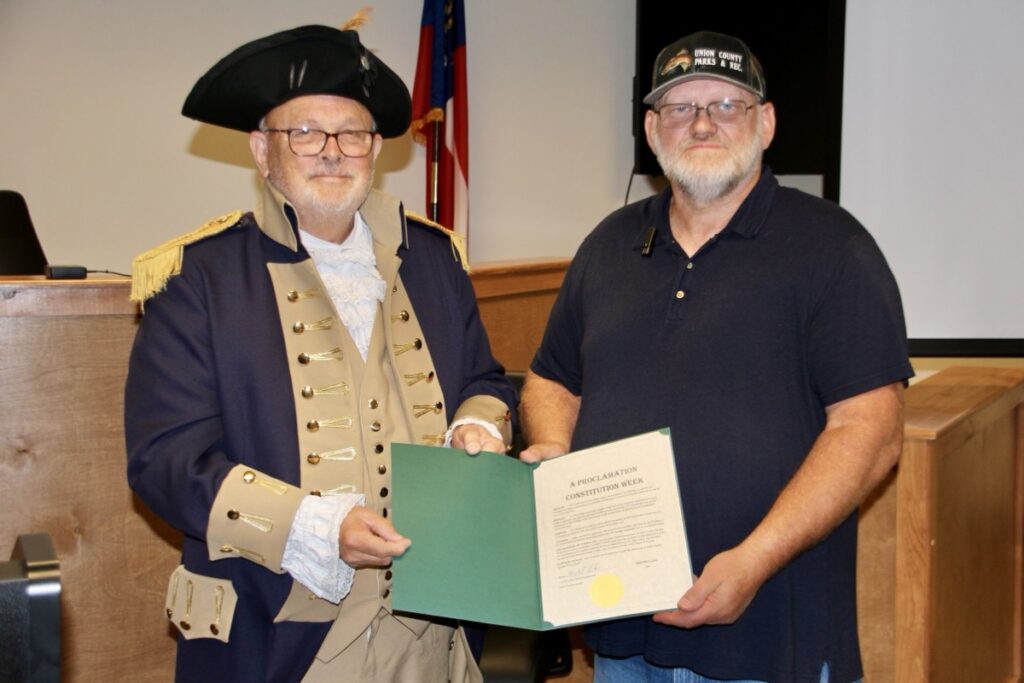 Jared Ogden with the Blue Ridge Mountains Chapter Sons of the American Revolution accepting a Constitution Week proclamation from Sole Commissioner Harold Collins on Sept. 18. Photo By Shawn Jarrard