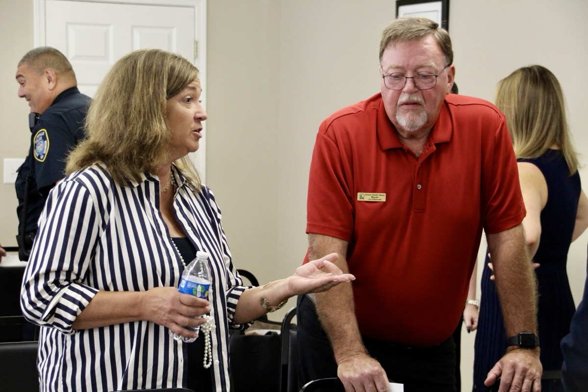 Young Harris Mayor Andrea Gibby discussing the opportunities available through GMA with Blairsville Mayor Buddy Moore and others on Sept. 26. Photo by Shawn Jarrard
