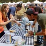 The Biskit Eatin’ Contest featured plenty of hungry competitors over the four days of the Sorghum in the Mountains Festival, made sweet with sorghum syrup cooked fresh inside Meeks Park. Photo by Lowell Nicholson