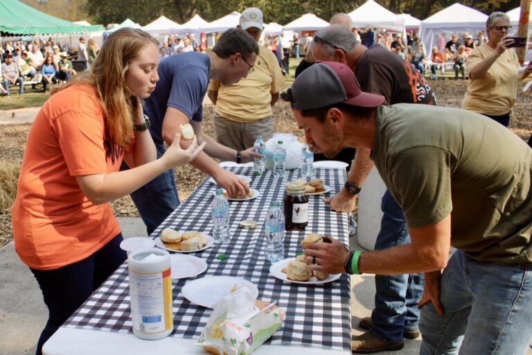 The Biskit Eatin’ Contest featured plenty of hungry competitors over the four days of the Sorghum in the Mountains Festival, made sweet with sorghum syrup cooked fresh inside Meeks Park. Photo by Lowell Nicholson