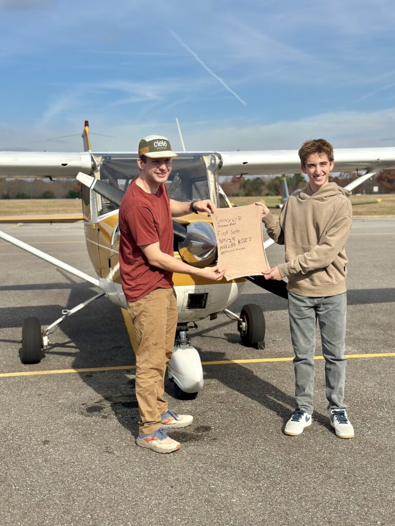 (L-R) Flight Instructor Jason Hinson with Sawyer Alexander after the young man’s first solo flight Nov. 15.