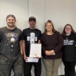Mark Kelley, pictured here holding a certificate of completion, was proud to have his son Christian, wife Rebecca and daughter-in-law Abby attend his North Enotah Drug Court Program graduation this month. Photo by Samantha Laratta