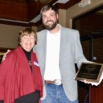 Dr. Kathleen Thompson receiving the “Preservationist of the Year Award” from Historical Society President Mike Cook. Thompson nominated the society for a major state award, which it won. Photo by Brittany Holbrooks