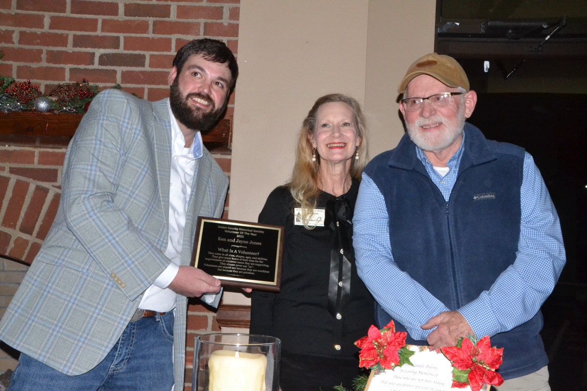 Society President Cook with “Volunteers of the Year” Jayne and Ken Jones in the Dec. 16 Christmas Banquet. Photo by Brittany Holbrooks