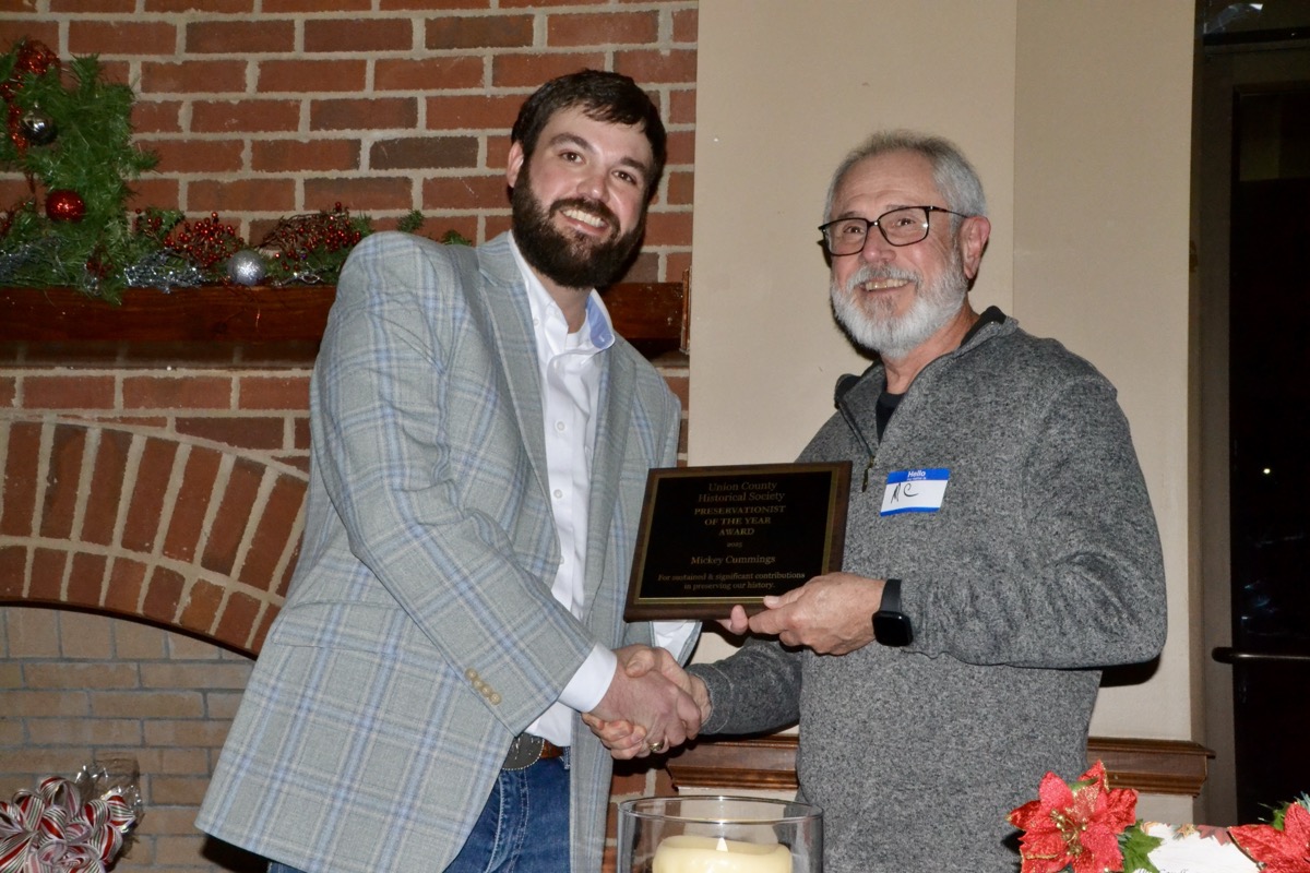 Cook was pleased to present a second “Preservationist of the Year Award” to Mickey Cummings in recognition for his hard work on the Collins Cabin restoration project. Photo by Brittany Holbrooks