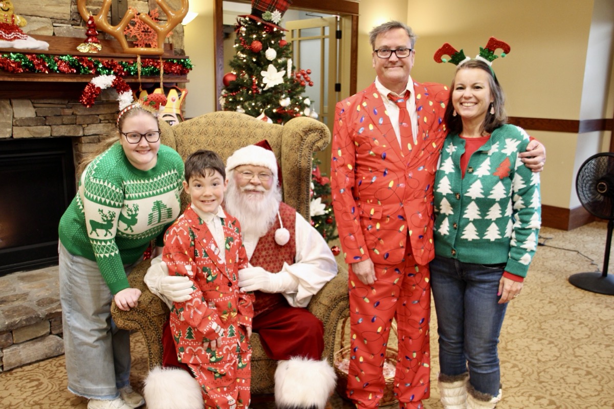 The Krout Family – Daughter Camryn, Son Sam, Dad David and Mom Sonja – dressed in their festive best to enjoy Christmas on the town Saturday, pictured here with Santa at the Holly Jolly event. Photo by Shawn Jarrard
