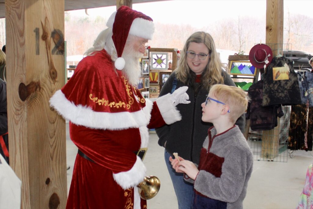 Kris Kringle had a wonderful time speaking with children during his namesake holiday shopping event at the Union County Farmers Market on Saturday, Dec. 6. Photo by Lowell Nicholson