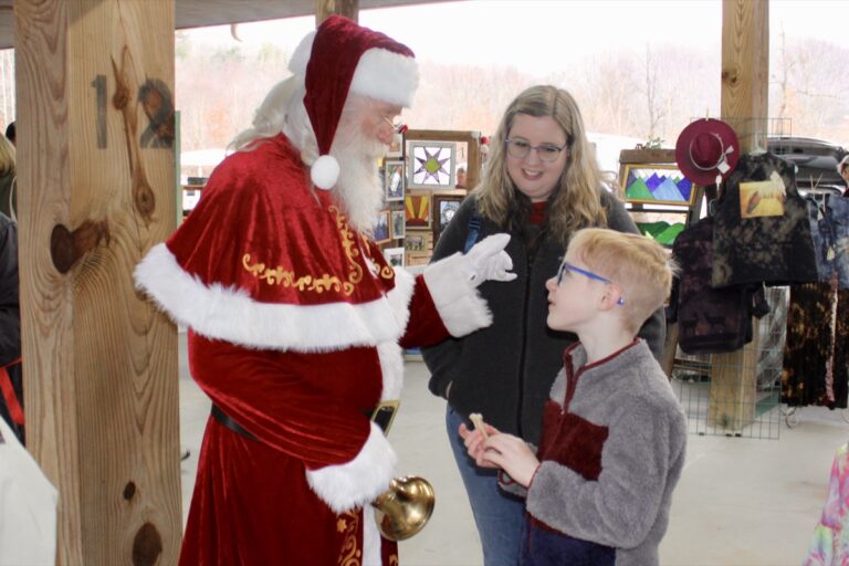 Kris Kringle had a wonderful time speaking with children during his namesake holiday shopping event at the Union County Farmers Market on Saturday, Dec. 6. Photo by Lowell Nicholson