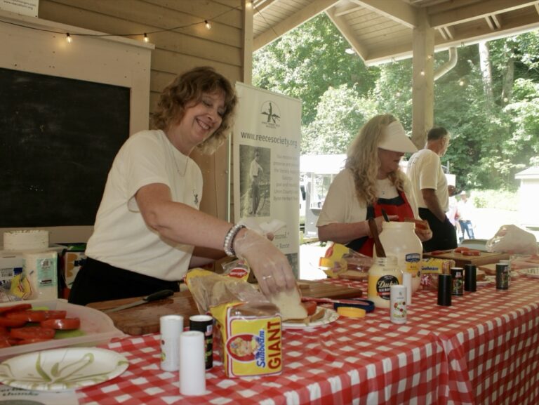 Volunteers made and distributed free tomato sandwiches during the popular Maters & Music Festival hosted by the Byron Herbert Reece Society this month. Photo by Brittany Holbrooks