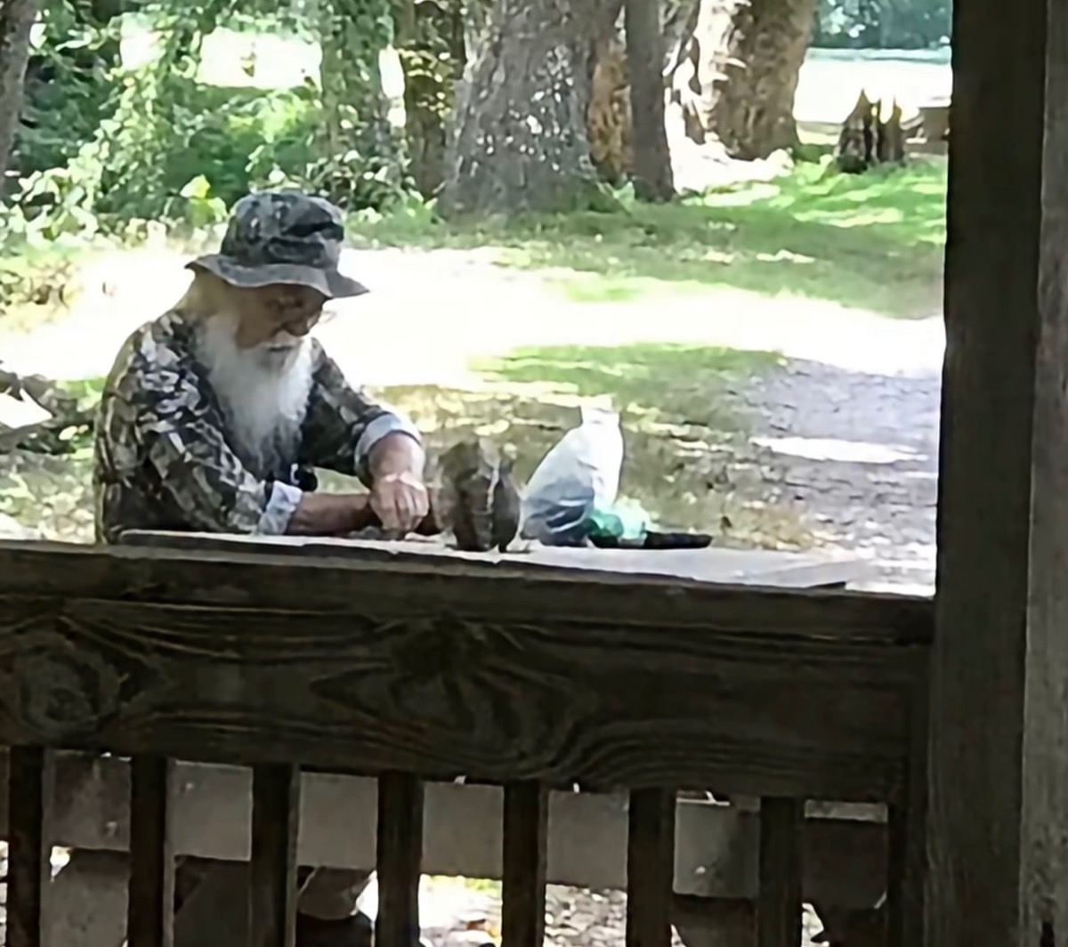Steve “The Squirrel Man” Johnson doing one of the things he loved best in life – feeding local wildlife he had befriended at Meeks Park. Photo/Submitted