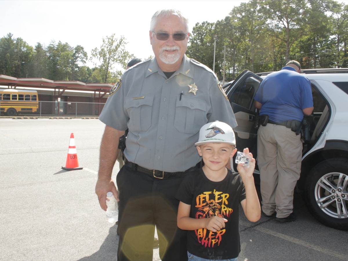 Union County Sheriff Shawn Dyer presented young Brandon Weaver with a UCSO Challenge Coin at the recent Child Safety Seat Check at the Primary School. Photo by Brittany Holbrooks