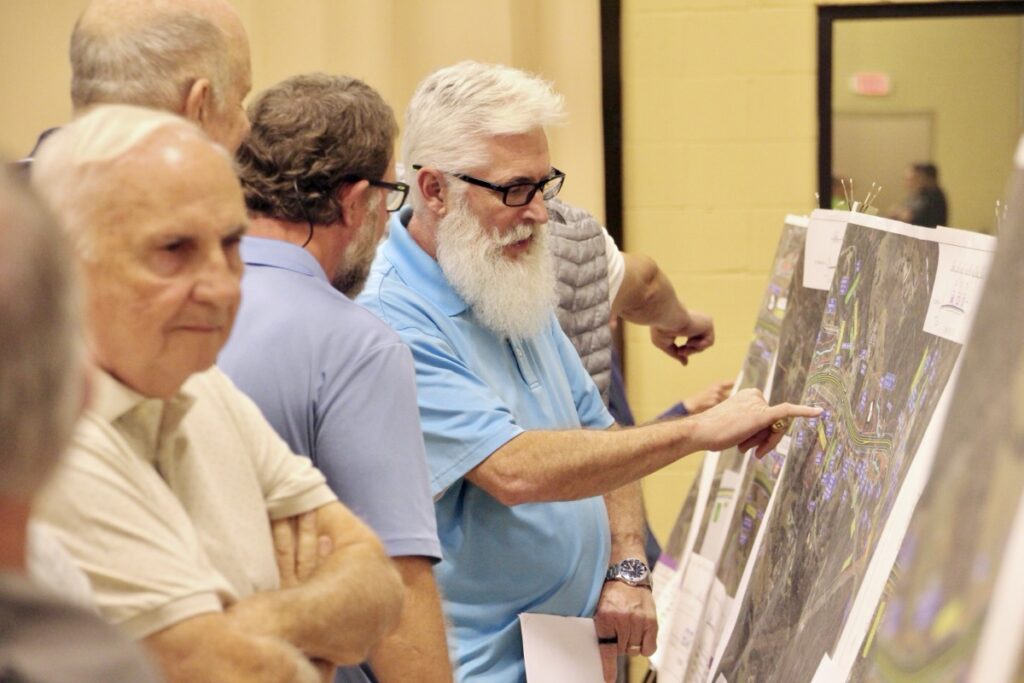 Residents asked GDOT employees detailed questions about Murphy Highway project maps stationed around the Multipurpose Gym last week. Photo by Shawn Jarrard
