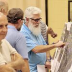 Residents asked GDOT employees detailed questions about Murphy Highway project maps stationed around the Multipurpose Gym last week. Photo by Shawn Jarrard