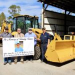 (L-R) Road Supervisor Christian Edwards, County Manager Tony Hughes, Commissioner Harold Collins and Maintenance Shop Supervisor Charles “Snuffy” Wright met last week to dedicate the new backhoe to Tommy Tanner. Photo by Shawn Jarrard