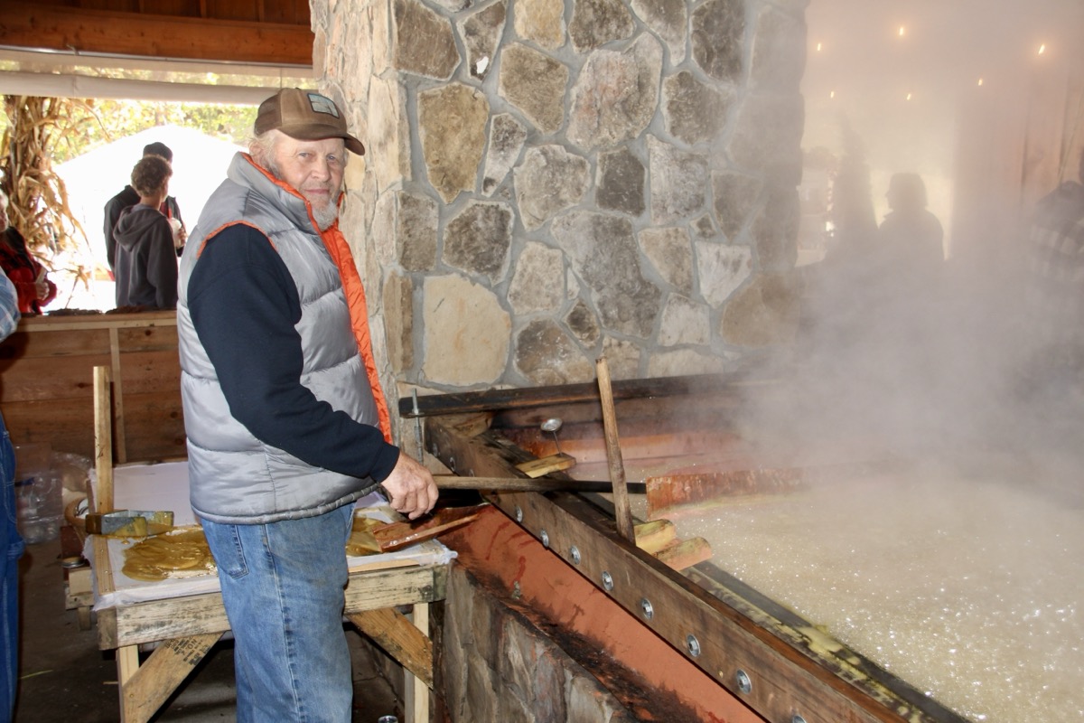 Resident Don Collins spent hours at the sorghum syrup pan as festival organizers sold hundreds of gallons of the fresh-cooked sweet stuff over the weekend. Photo by Shawn Jarrard