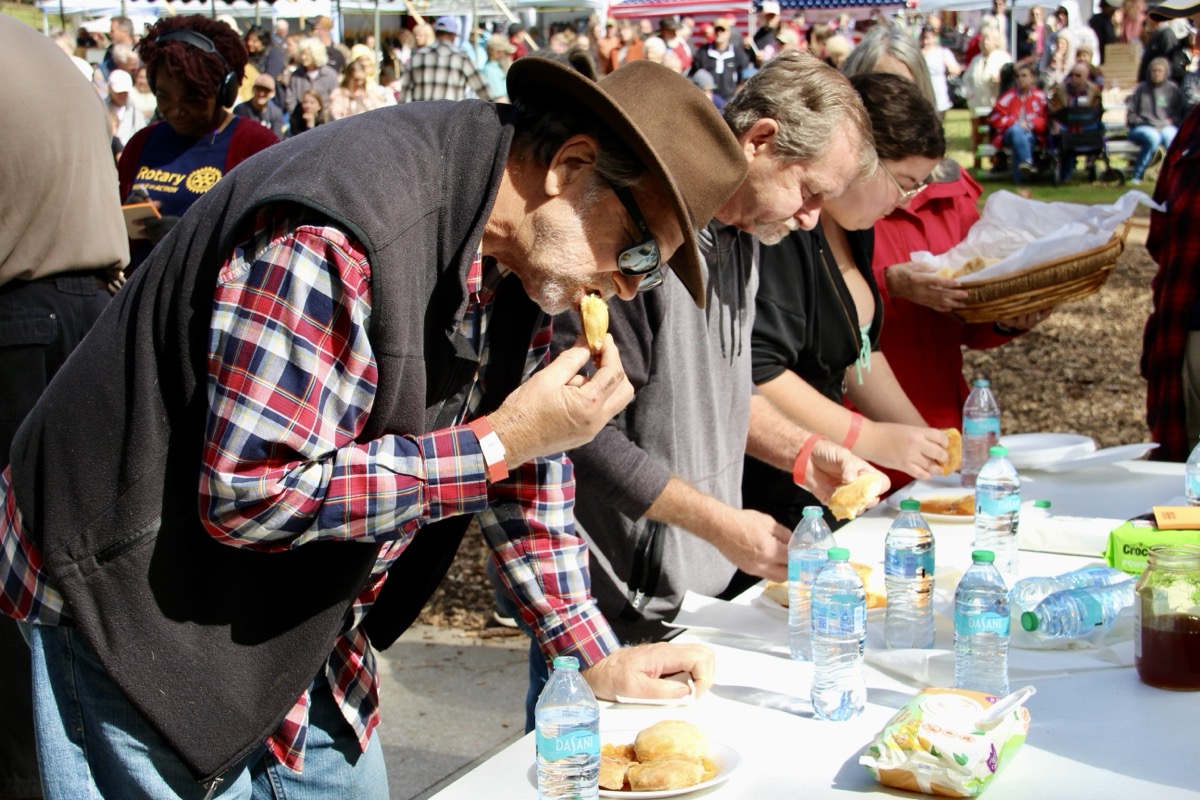 The ever-popular Biskit Eatin’ Contest returned to Sorghum in the Mountains, with event emcee Libby Stevens starting the competition with her usual ready, set, SOP! Photo by Shawn Jarrard